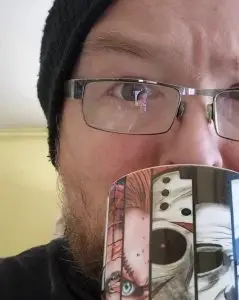 Jim drinking tea from his horror mug.