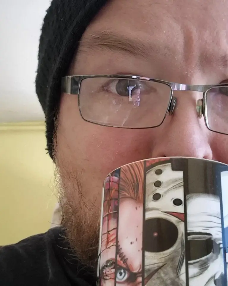Jim drinking tea from his horror mug.