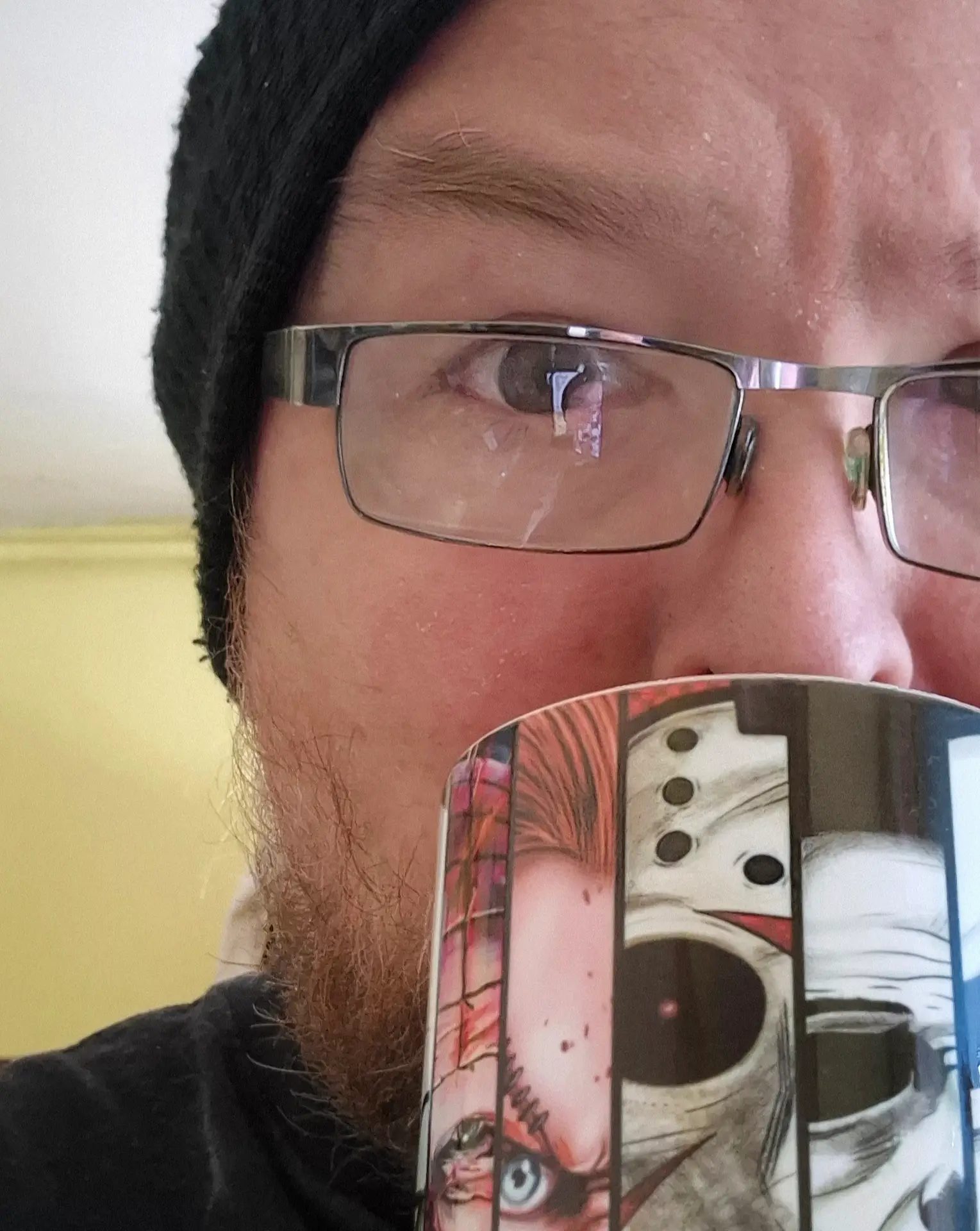 Jim drinking tea from his horror mug.